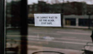 "A sign on a door saying We cannot wait to see you again, stay safe"