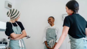 Three coffee shop employees talking.